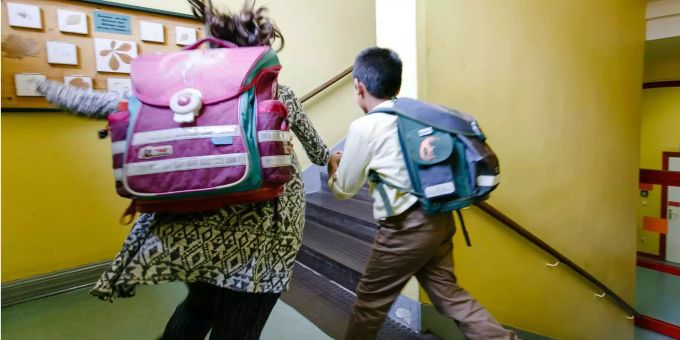 Zwei Schulkinder laufen durch das Treppenhaus ihrer Grundschule. (Symbolbild) Schule Zollikon Ukraine-Krieg