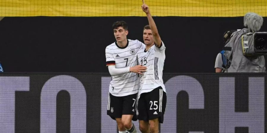 Kai Havertz (l) und Thomas Müller feiern das 4:0. Foto: Federico Gambarini/dpa