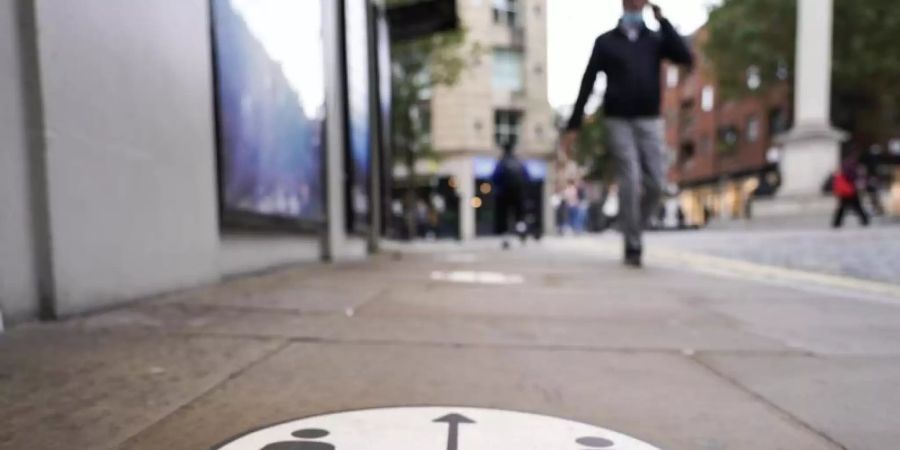 Schild zur sozialen Distanzierung in London. Kürzlich hatten Experten Von einer - noch geringen - Ausbreitung der Mutante in Grossbritannien berichtet. Foto: Alberto Pezzali/AP/dpa