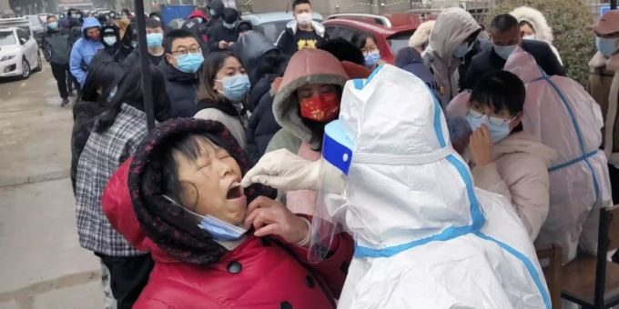 Ein Mitarbeiter des Gesundheitswesens in einem Schutzanzug entnimmt Corona-Tests bei Einwohnern. Foto: CHINATOPIX/AP/dpa Ein Mitarbeiter des Gesundheitswesens in einem Schutzanzug entnimmt Corona-Tests bei Einwohnern. Foto: CHINATOPIX/AP/dpa