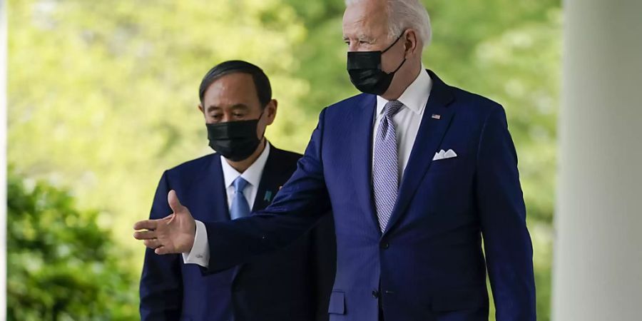 Joe Biden, Präsident der USA, und Japans Ministerpräsident Yoshihide Suga kommen aus dem Oval Office und sind auf dem Weg zu einer Pressekonferenz. Foto: Andrew Harnik/AP/dpa