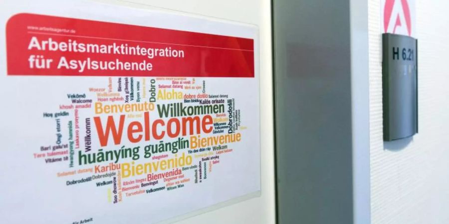 Ein Aufkleber «Arbeitsmarktintegration für Asylsuchende. Welcome» hängt in der Registrierungsstelle für Flüchtlinge in Berlin. Foto: Soeren Stache