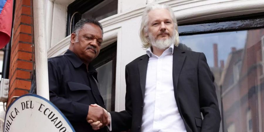 Julian Assange 2015 auf dem Balkon mit einem US-Pfarrer.