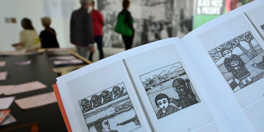 Eine Frau hält auf der documenta fifteen im Fridericianum die Broschüre mit dem Titel «Presence des Femmes», die 1988 in Algier erschienen ist, in den Händen. Sie enthält weitere als antisemitisch kritisierte Motive.