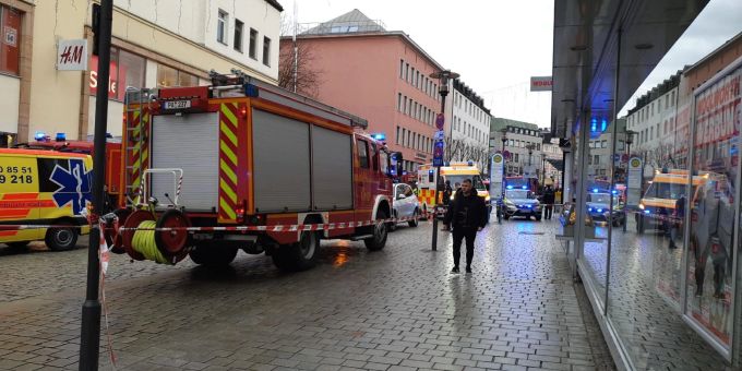 Einsatzkräfte von Feuerwehr und Rettungsdienst stehen am Freitag in der Innenstadt am Einsatzort. passau unfall tot verletzt