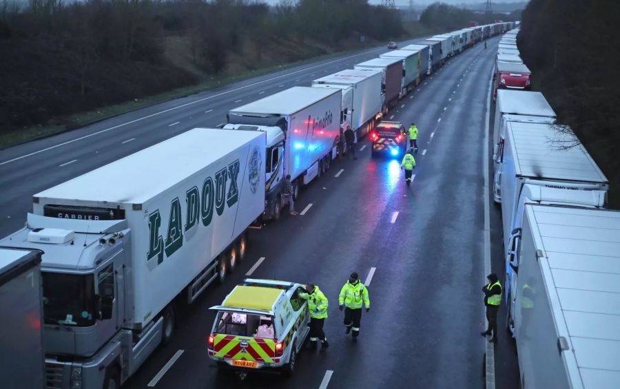 Beamte der Küstenwache verteilen Wasserflaschen an LKW-Fahrer, die auf der M20 stehen.