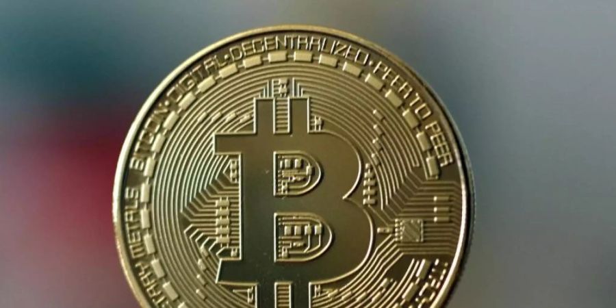 Ein Bitcoin kostet erstmals mehr als 21.000 Dollar. Foto: Ina Fassbender/dpa