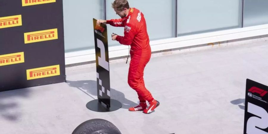 Sebastian Vettel vertauscht in Kanada im Parc Fermé die Nummerntafeln für Platz eins und zwei. Foto: Paul Chiasson/The Canadian Press/AP