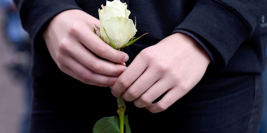 Vielen Kindern hilft es, ihre Trauer auszuleben - wenn sie etwa bei der Beerdigung einbezogen werden und eine Rose auf das Grab legen dürfen.
