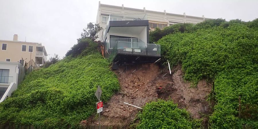 A house is seen after a landslip took out some of its foundations, forcing the road to be closed in Shortland esplanade, Newcastle, Sunday , March 21, 2021. More rain is forecast for the NSW coast and other parts of the state, with flood warnings in place and the premier advising residents to stay home. (AAP Image/Darren Pateman) NO ARCHIVING