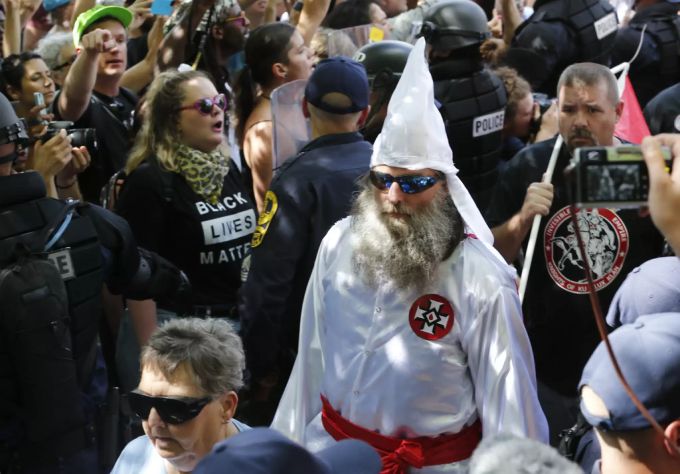 Mitglieder der KKK werden von der Polizei an «Black Lives Matter»-Protestierende vorbei eskortiert, Juli 2018. KKK
