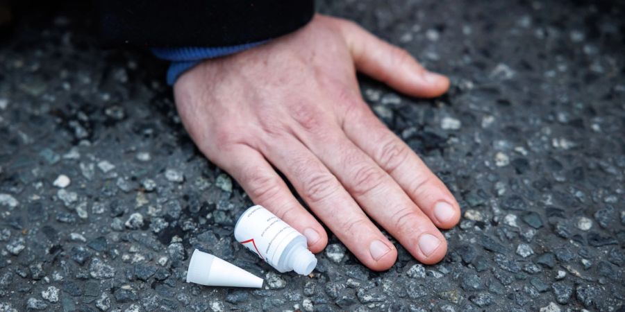 Ein Klimaaktivist hat sich am Stachus mit seiner Hand auf die Strasse geklebt.