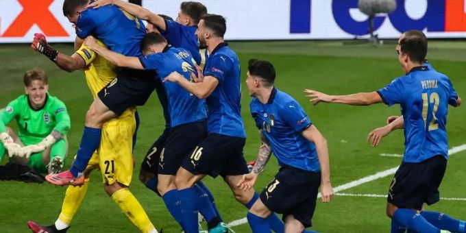 Italiens Spieler jubeln nach dem gewonnen Elfmeterschiessen mit ihrem Torhüter Gianluigi Donnarumma. Foto: Christian Charisius/dpa Coronavirus London