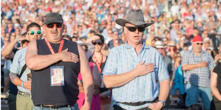 Schwingerfans singen die Schweizer Nationalhymne am Eidgenössischen Schwing- und Älplerfest.