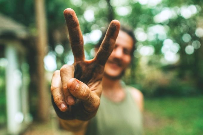 Etwas nicht persönlich zu nehmen ist lernbar und bedeutet innerer Frieden. Mann macht Peace-Zeichen