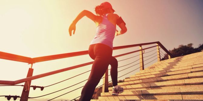 Frau joggen Treppe hoch Sonne Sportklamotten