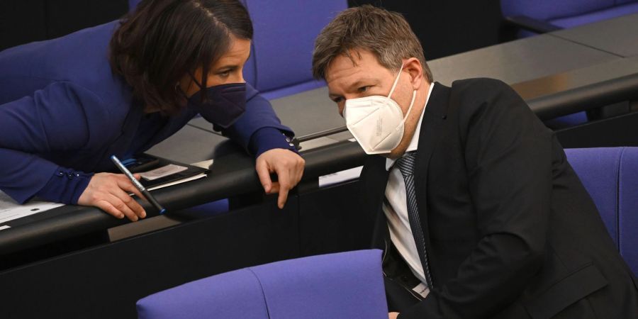 Annalena Baerbock, Bundesaussenministerin und Robert Habeck (beide Grüne), Bundeswirtschaftsminister, unterhalten sich während der Sitzung des Bundestags.