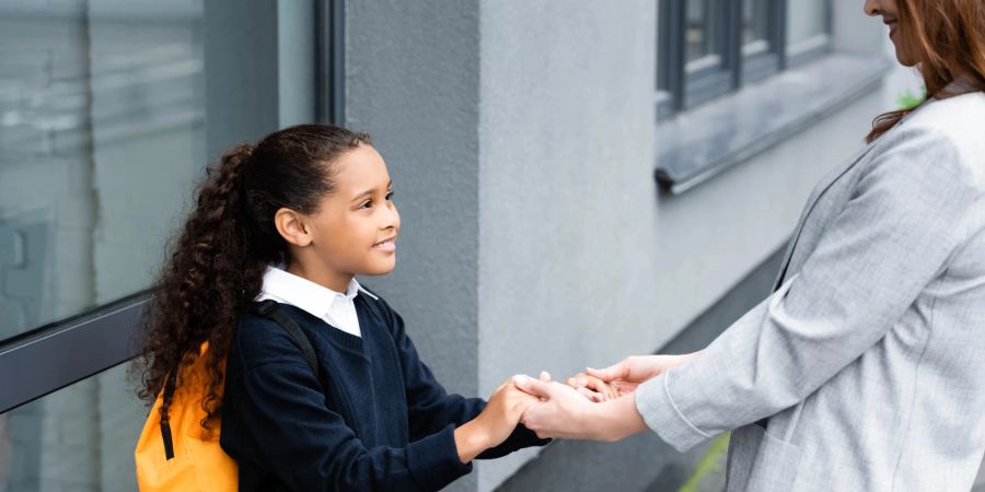 Mutter und Tochter vor der Schule