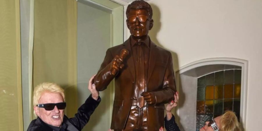 Der Volkssänger Heino und seine Frau Hannelore stehen neben der Heino-Statue im Historischen Kurhaus. Foto: Horst Ossinger//dpa