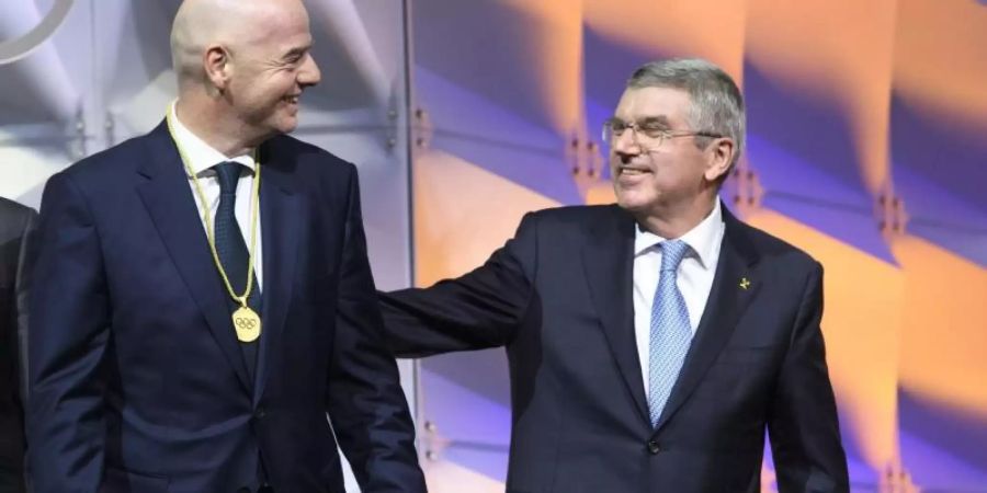 Zwischen FIFA-Boss Gianni Infantino (l), und IOC-Chef Thomas Bach besteht offenbar Redebedarf. Foto: Laurent Gillieron/KEYSTONE/dpa