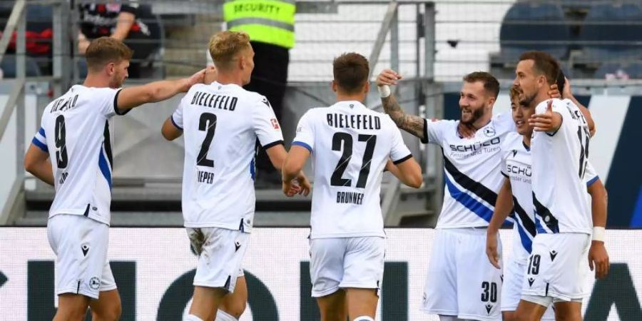 Die Spieler von Arminia Bielefeld feiern das 1:0 gegen Eintracht Frankfurt. Foto: Arne Dedert/dpa