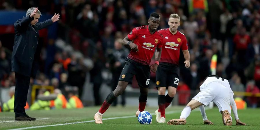 Jose Mourinho gestikuliert an der Seitenlinie, während Paul Pogba den Ball am Fuss hat.