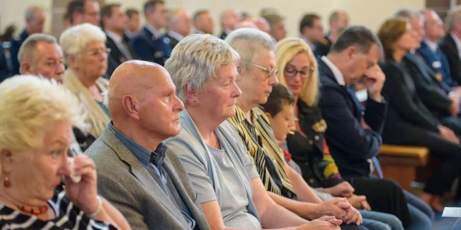 Angehörige der Opfer des Flugunglücks von Ramstein (D) von 1988 sitzen in dem Gedenkgottesdienst.
