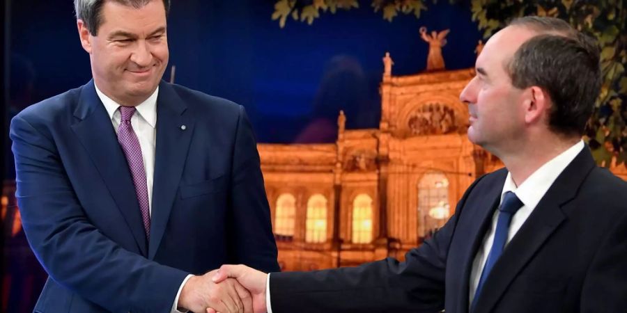 Münchens Ministerpräsident Markus Söder (L) schüttelt die Hand von Hubert Aiwanger von den Freien Wählern.