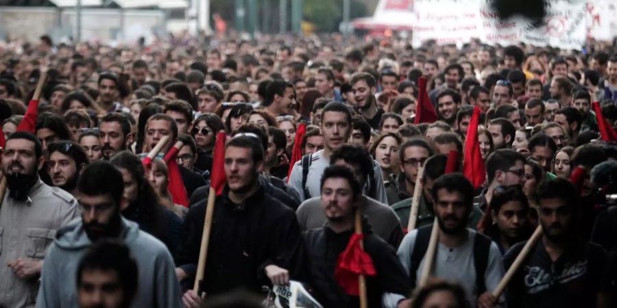 Junge Leute laufen als Gruppe auf einer Strasse und demonstrieren.