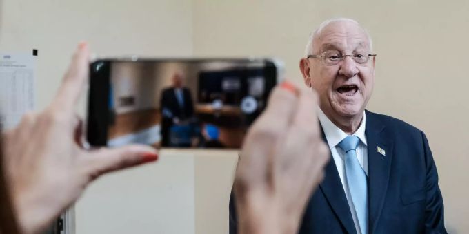 Eine Frau fotografiert Reuven Rivlin, Staatspräsident von Israel, bei der Stimmabgabe mit dem Handy. reuven revlin