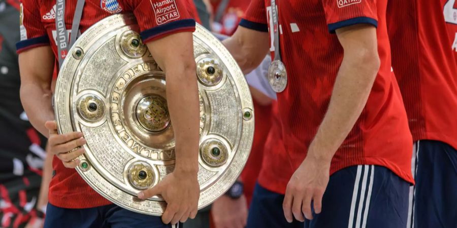 Ein Spieler des FC Bayern München mit der Meisterschale.