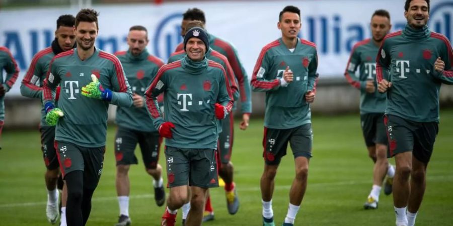 Die Spieler des FC Bayern laufen sich warm. Vor dem Gipfel gegen den BVB treffen die Münchner in der Bundesliga auf den SC Freiburg. Foto: Sina Schuldt/dpa