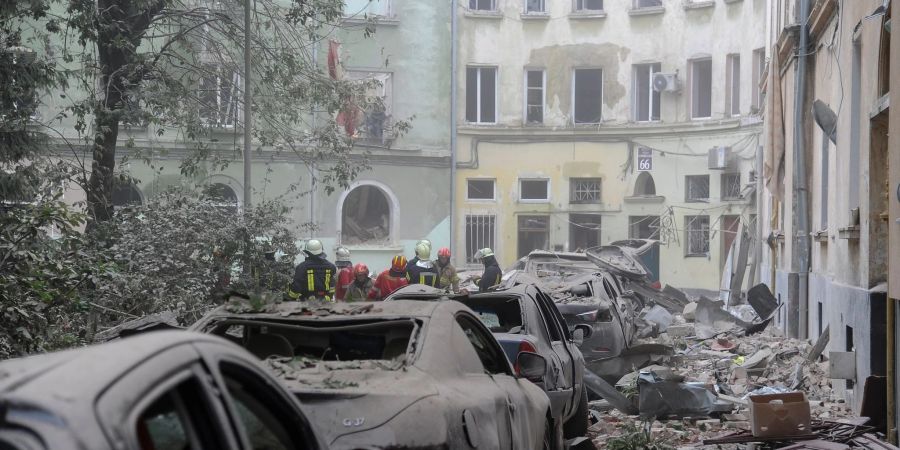 Rettungskräfte suchen in den Trümmern am Angriffsort nach Überlebenden und Todesopfern.