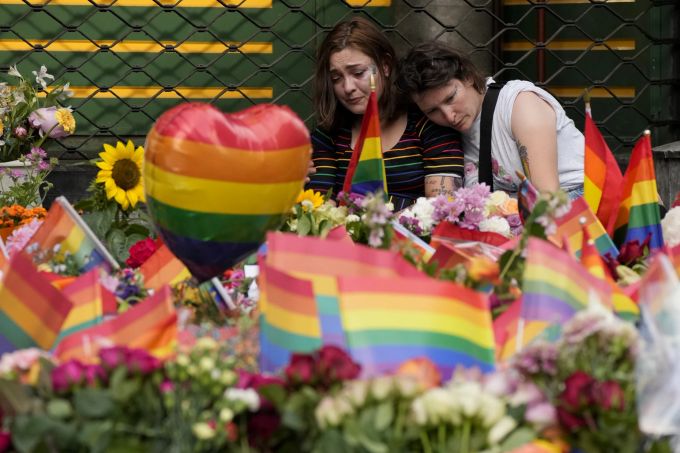 People comfort each other at the scene of a shooting in central Oslo, Norway, Saturday, June 25, 2022. A gunman who opened fire in Oslo’s nightlife district has killed two people and left more than 20 others injured during the LGBTQ Pride festival in Norway's capital. (AP Photo/Sergei Grits) APTOPIX Norway Shooting