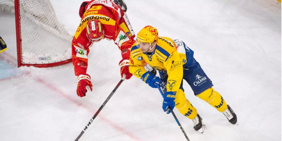 Michael Hügli (links, EHC Biel) stürzt im Zweikampf mit Inti Pestoni (HC Davos).