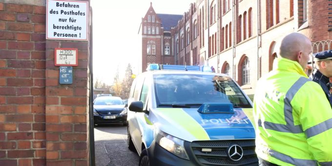 Die Durchsuchung des Postgebäudes in Frankfurt an der Oder ergab keine Hinweise auf eine mögliche Bedrohung. Polizisten sperren die Zufahrt zu einem Postgebäude im Zentrum von Frankfurt an der Oder ab.
