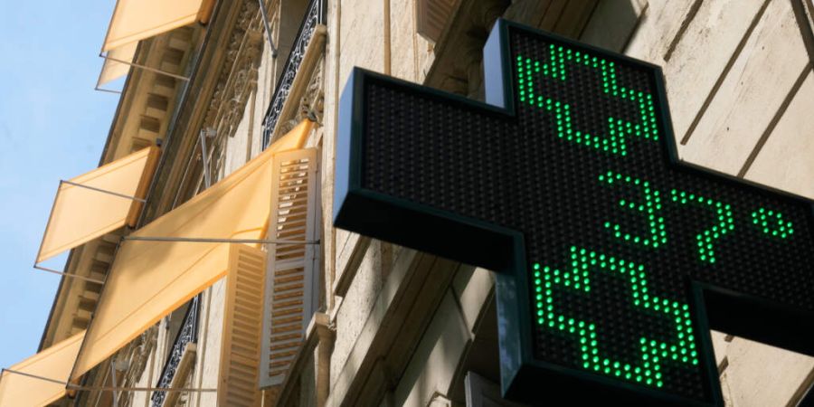 Auf einem Schild vor einer Apotheke wird eine Temperatur von 37 Grad Celsius angezeigt. Foto: Michel Euler/AP/dpa