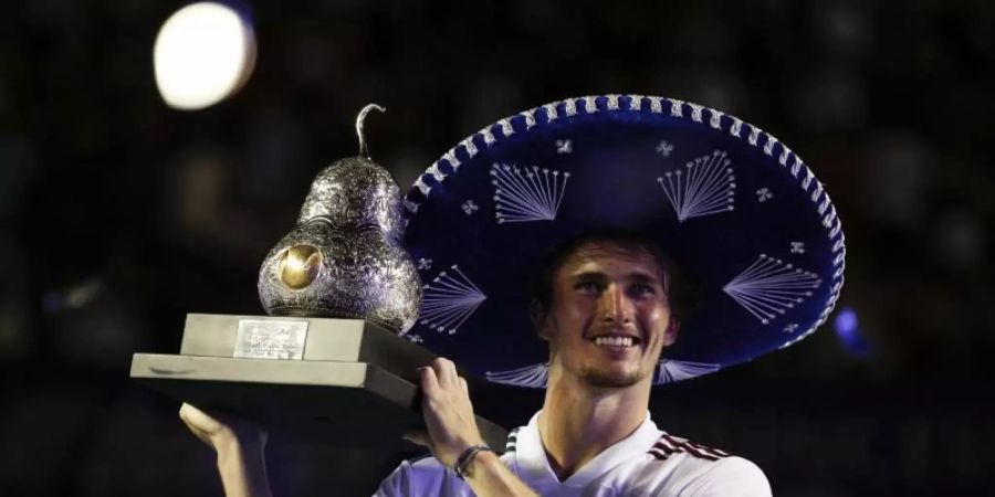 Alexander Zverev posiert nach seinem Sieg in Acapulco mit Sombrero und Trophäe. Foto: Rebecca Blackwell/AP/dpa