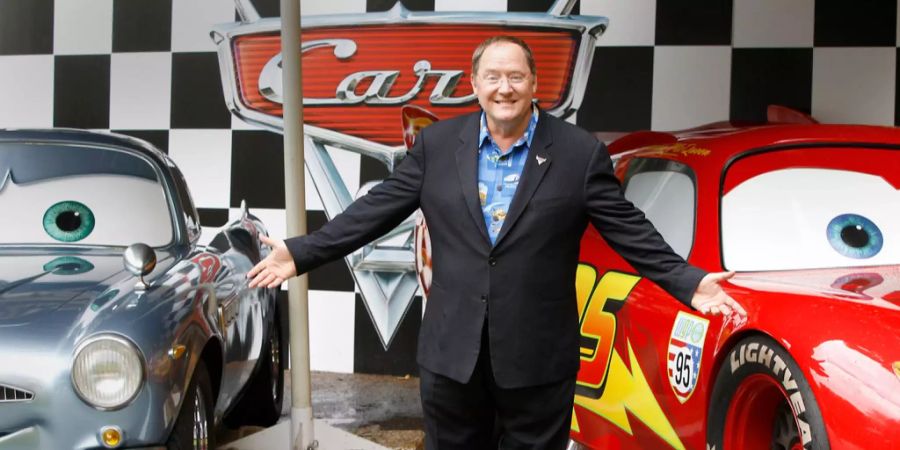 John Lasseter zwischen zwei Modellautos von «Cars».