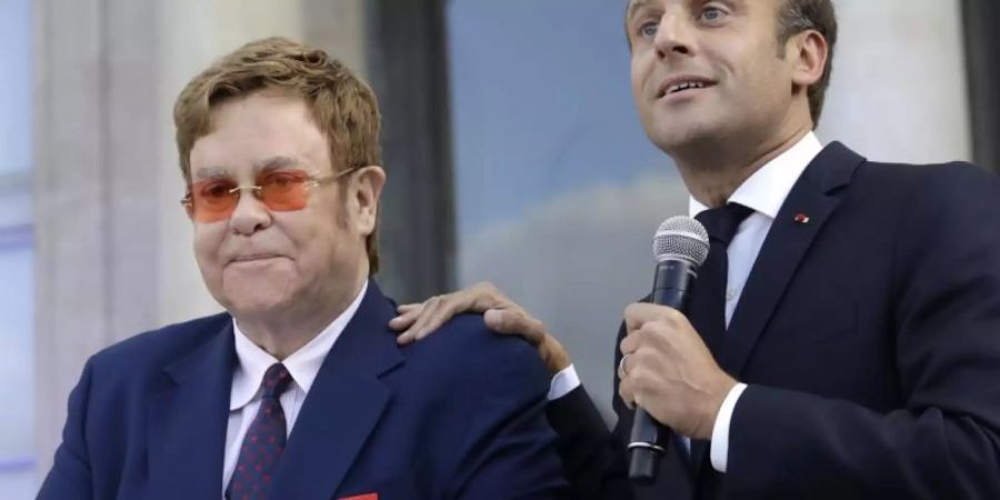 Frankreichs Präsident Macron hat den britischen Popstar Elton John zum Ritter der Ehrenlegion gemacht. Foto: Lewis Joly/AP