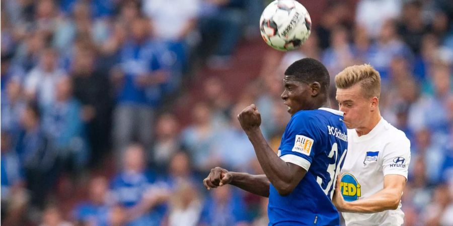 Schalkes Breel Embolo (l.) und Berlins Maximilian Mittelstädt kämpfen im Kopfballduell um den Ball.