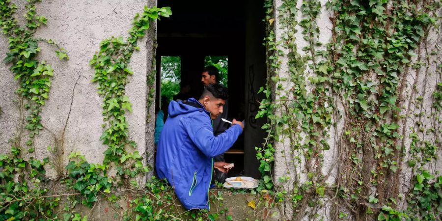 Flüchtlinge In Bihac (BIH) verharren draussen und nehmen Nachrung zu sich. (Archivbild)