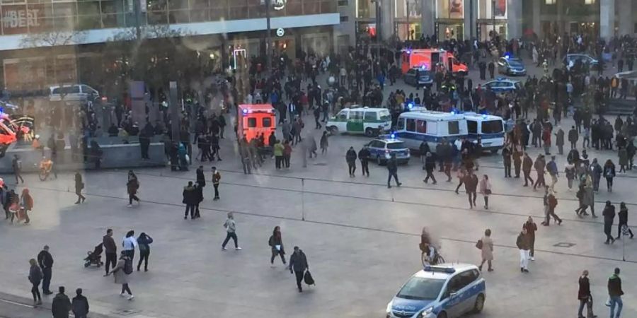 Menschengruppen, Polizeifahrzeuge und Krankenwagen stehen auf dem Alexanderplatz. Nach einem Aufruf in sozialen Medien ist es dort zu einer Massenschlägerei gekommen. Foto: Monika Wendel