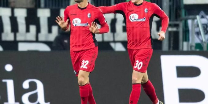 Torschütze Vincenzo Grifo (l) feiert mit seinem Teamkollegen Christian Günter den Treffer gegen Gladbach. Foto: Marcel Kusch