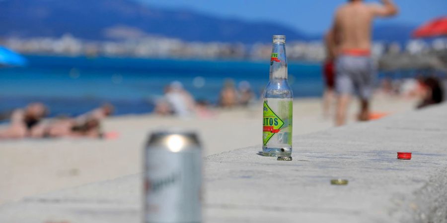 Leere Flaschen und Dosen am Strand Arenal auf Mallorca.