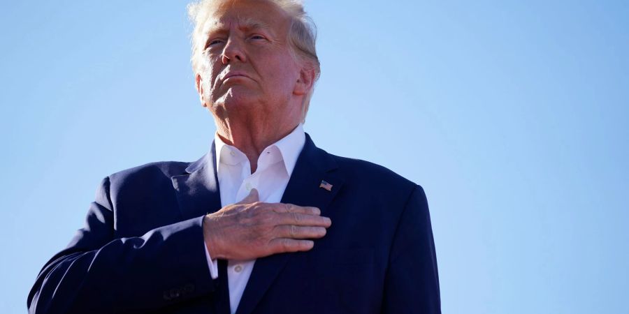 Der ehemalige US-Präsident Donald Trump steht bei der Nationalhymne bei einer Wahlkampfveranstaltung auf dem Waco Regional Airport in Texas.