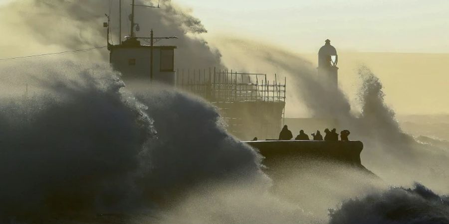 Wellen prallen gegen Strandmauer im walisischen Porthcawl