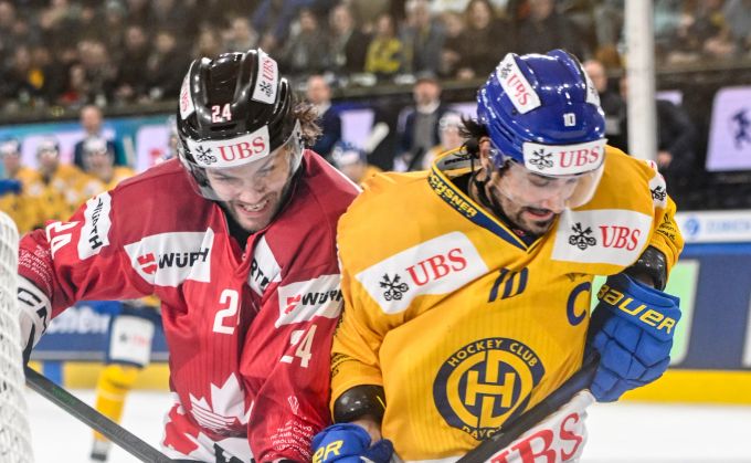 Andres Ambühl vom HC Davos im Zweikampf mit Kanadas Ty Smith beim Spengler Cup 2023. HC Davos
