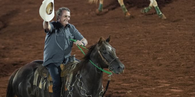 Brazilian President Jair Bolsonaro, who is running for a second term, rides a horse at the the Barretos Rodeo International Festival in Barretos, Sao Paulo state Brazil, Friday, Aug. 26, 2022. Brazil's general elections are scheduled for Oct. 2, 2022. (AP Photo/Andre Penner) Brazil Elections
