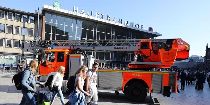 Reisende gehen mit ihren Koffern vor dem Kölner Hauptbahnhof. Reisende gehen mit ihren Koffern vor dem Kölner Hauptbahnhof.